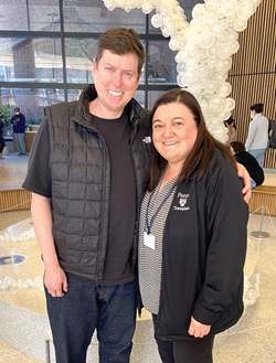 Evan Rood, left, with Maria Crespo, MD, in the lobby of the HUP Pavilion.